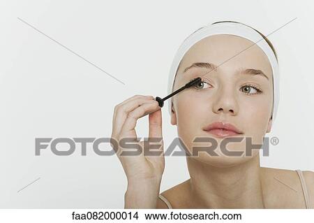 Preteen girl putting on mascara View Large Photo Image Picture - Preteen girl putting on mascara. Fotosearch