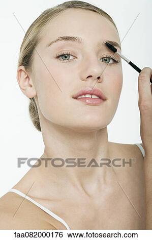 Preteen girl using eyebrow brush View Large Photo Image Stock Photograph - Preteen girl using eyebrow brush. Fotosearch