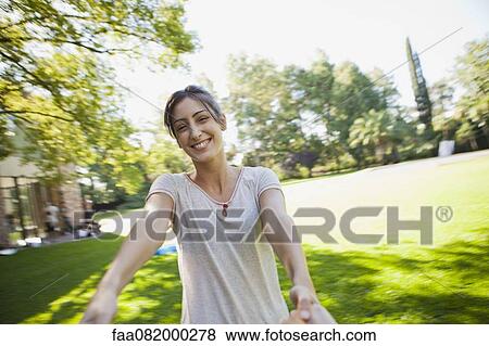 Stock Photo - Spinning with girlfriend, personal perspective. Fotosearch