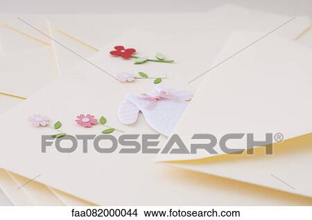 Stationery embellished with miniature baby clothing and flowers View Large Photo Image Picture - Stationery embellished with miniature baby clothing and flowers. Fotosearch
