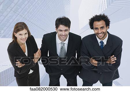 Team of executives smiling confidently with skyscrapers superimposed on background View Large Photo Image Stock Image - Team of executives smiling confidently with skyscrapers superimposed on background. Fotosearch