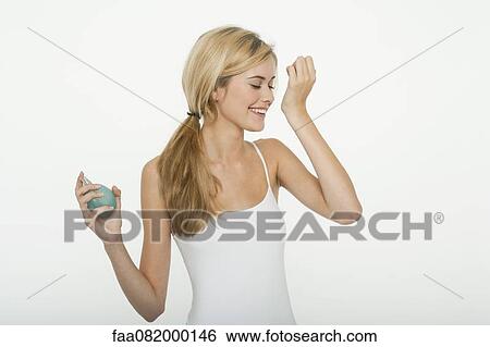 Teen girl smelling perfume View Large Photo Image Stock Photograph - Teen girl smelling perfume. Fotosearch