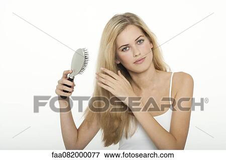 Stock Photo - Teenage girl brushing her hair. Fotosearch