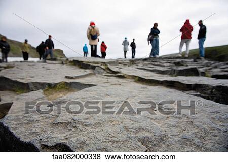 Tourists standing at the edge of Gulfoss waterfall, Iceland View Large Photo Image Stock Photo - Tourists standing at the edge of Gulfoss waterfall, Iceland. Fotosearch