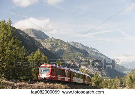Stock Photo - Train moving through mountain landscape. Fotosearch