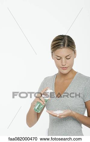 Woman preparing to use facial cleanser View Large Photo Image Stock Image - Woman preparing to use facial cleanser. Fotosearch