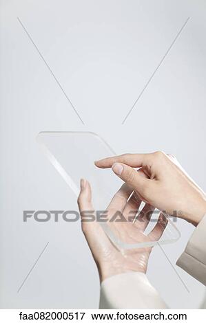 Woman's hands holding transparent digital tablet View Large Photo Image Stock Photo - Woman's hands holding transparent digital tablet. Fotosearch