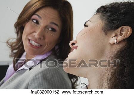 Stock Image - Women chatting in office. Fotosearch
