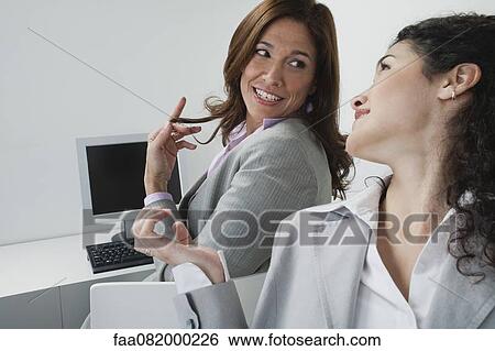 Stock Photograph - Women chatting in office. Fotosearch
