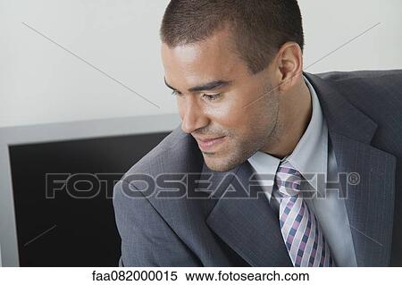 Young businessman looking away in thought View Large Photo Image Stock Photography - Young businessman looking away in thought. Fotosearch