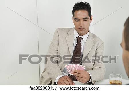 Young businessman playing cards View Large Photo Image Stock Photo - Young businessman playing cards. Fotosearch