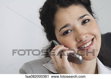 Young businesswoman talking on cell phone, portrait View Large Photo Image Stock Image - Young businesswoman talking on cell phone, portrait. Fotosearch