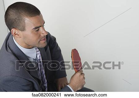 Stock Image - Young man playing table tennis in office. Fotosearch