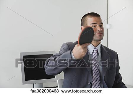 Stock Photo - Young man playing table tennis in office. Fotosearch