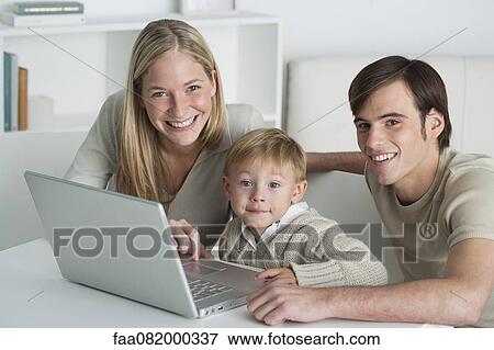Young parents and little boy with laptop computer, portrait View Large Photo Image Stock Photo - Young parents and little boy with laptop computer, portrait. Fotosearch