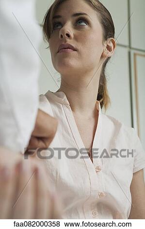 Young woman being examined by doctor View Large Photo Image Stock Photo - Young woman being examined by doctor. Fotosearch