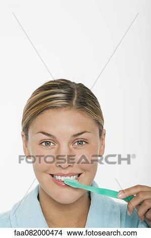 Young woman brushing her teeth View Large Photo Image Picture - Young woman brushing her teeth. Fotosearch
