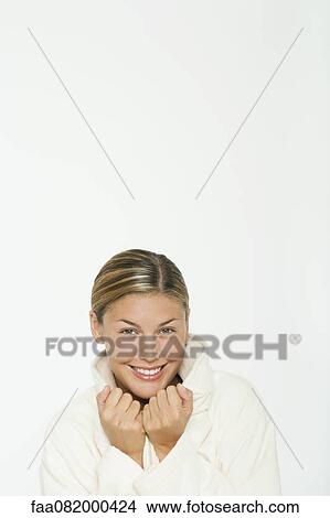 Picture - Young woman in bathrobe smiling, portrait. Fotosearch