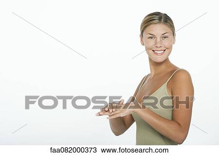 Young woman moisturizing her hands View Large Photo Image Stock Image - Young woman moisturizing her hands. Fotosearch