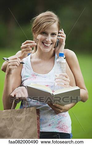 Young woman multitasking View Large Photo Image Stock Image - Young woman multitasking. Fotosearch