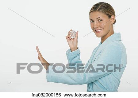 Stock Photograph - Young woman using nail brush. Fotosearch