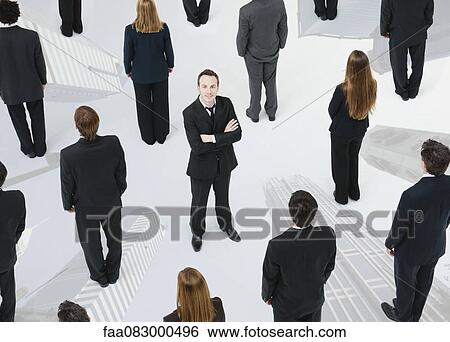 Ambitious businessman standing out from the crowd View Large Photo Image Stock Photograph - Ambitious businessman standing out from the crowd. Fotosearch