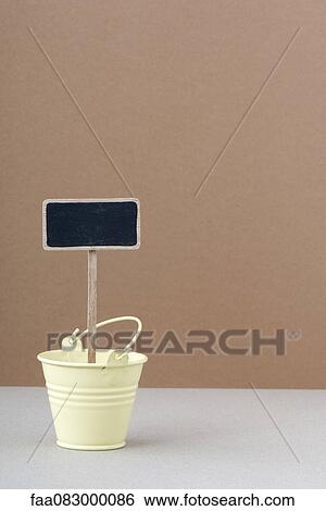 Stock Photograph - Blank sign in gardening pot. Fotosearch