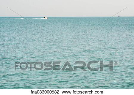 Boat and its wake lake michigan View Large Photo Image Stock Image - Boat and its wake lake michigan. Fotosearch