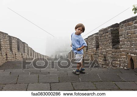 Stock Photograph - Boy looking over shoulder, Great Wall, China. Fotosearch