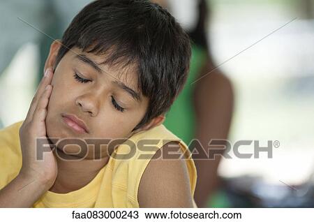 Boy resting head on chin, eyes closed View Large Photo Image Stock Image - Boy resting head on chin, eyes closed. Fotosearch