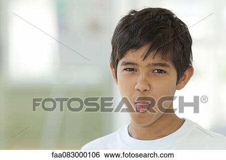 Boy sticking out tongue, portrait View Large Photo Image Stock Photograph - Boy sticking out tongue, portrait. Fotosearch