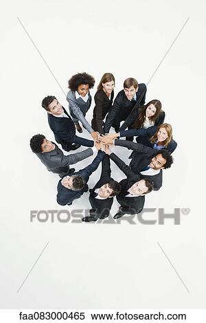 Business associates standing in circle with hands clasped in motivational exercise View Large Photo Image Stock Photography - Business associates standing in circle with hands clasped in motivational exercise. Fotosearch