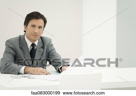 Business executive reviewing documents, portrait View Large Photo Image Stock Photo - Business executive reviewing documents, portrait. Fotosearch