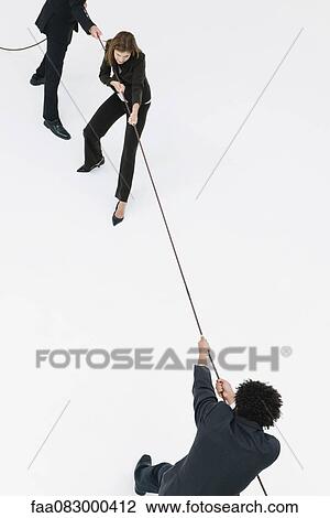 Business professionals playing tug-of-war View Large Photo Image Stock Image - Business professionals playing tug-of-war. Fotosearch