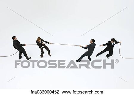 Business professionals playing tug-of-war View Large Photo Image Stock Image - Business professionals playing tug-of-war. Fotosearch