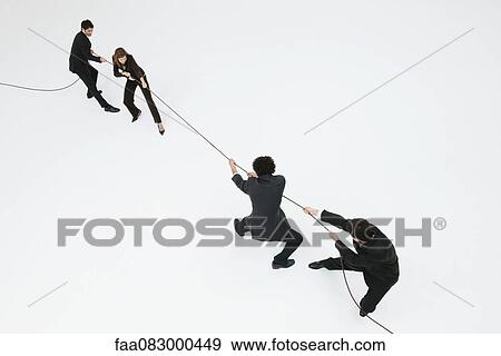 Business professionals playing tug-of-war View Large Photo Image Stock Photo - Business professionals playing tug-of-war. Fotosearch