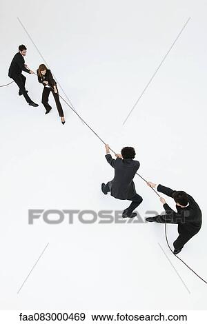Business professionals playing tug-of-war View Large Photo Image Stock Photo - Business professionals playing tug-of-war. Fotosearch