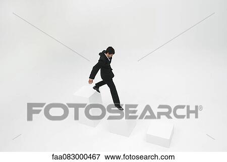 Stock Photo - Businessman descending steps. Fotosearch
