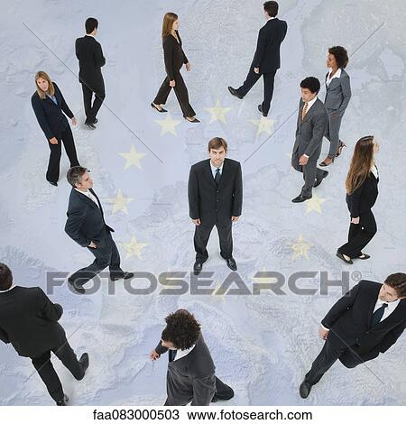 Stock Image - Businessman exhibits confidence standing out from the crowd. Fotosearch