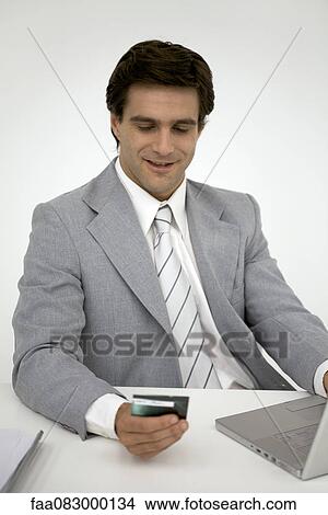 Picture - Businessman shopping online with credit card. Fotosearch