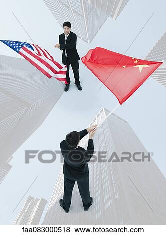 Businessman standing face to face, waving Chinese and American flags View Large Photo Image Stock Photo - Businessman standing face to face, waving Chinese and American flags. Fotosearch