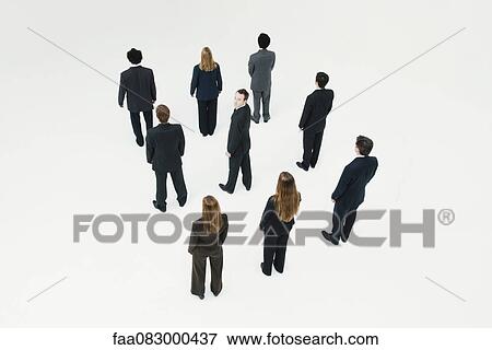 Businessman standing in midst of other anonymously dressed professionals View Large Photo Image Stock Photo - Businessman standing in midst of other anonymously dressed professionals. Fotosearch