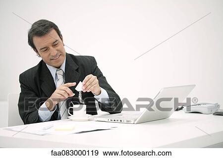 Businessman taking a coffee break at desk View Large Photo Image Stock Photo - Businessman taking a coffee break at desk. Fotosearch