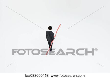 Stock Photo - Businessman with arrow pointed upward projecting financial growth. Fotosearch