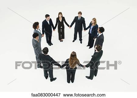 Businessmen and businesswomen standing together in circle holding hands View Large Photo Image Stock Photo - Businessmen and businesswomen standing together in circle holding hands. Fotosearch
