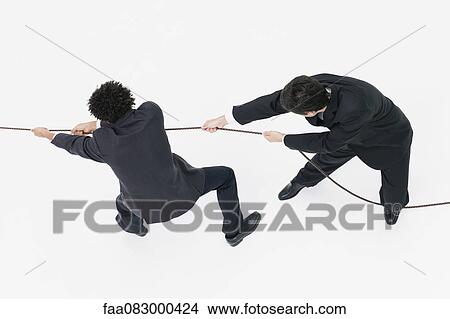 Businessmen playing tug-of-war View Large Photo Image Picture - Businessmen playing tug-of-war. Fotosearch