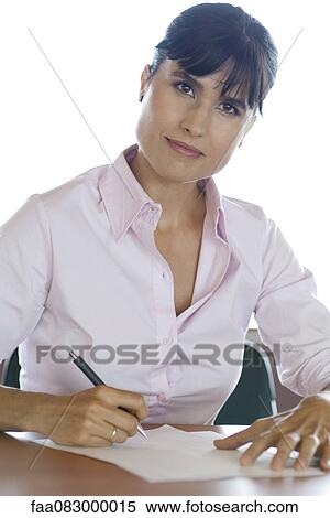 Stock Photography - Businesswoman sitting at desk, portrait. Fotosearch