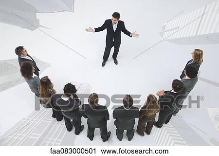 Stock Image - CEO leads motivational employee meeting. Fotosearch