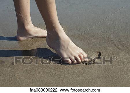 Child drawing in wet sand with foot, cropped View Large Photo Image Stock Image - Child drawing in wet sand with foot, cropped. Fotosearch