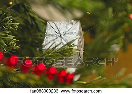 Stock Image - Christmas ornament shaped like a gift. Fotosearch